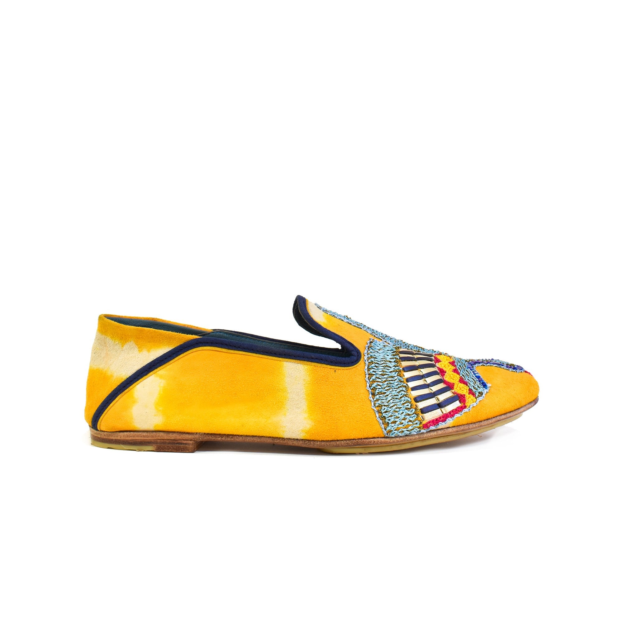 Side view of ANZU Moccasin TD saffron in yellow tie-dye suede leather with navy trim and embroidered vamp motif