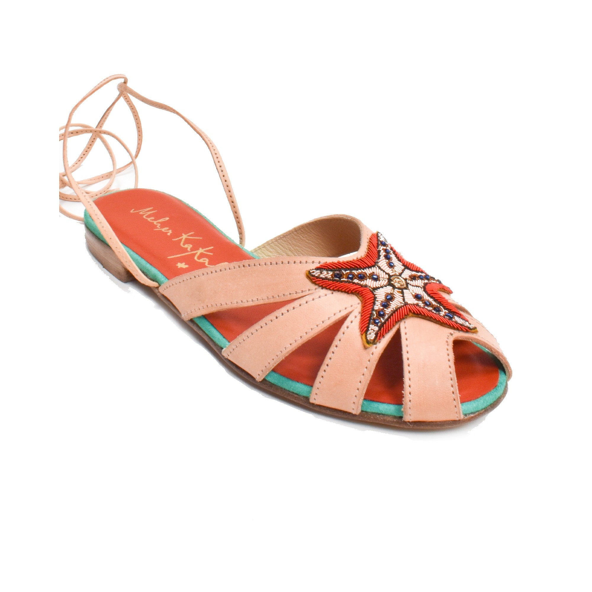 Close-up of Meher Kakalia EZILI SLIDE sandals featuring soft leather and hand-embroidered starfish motifs.