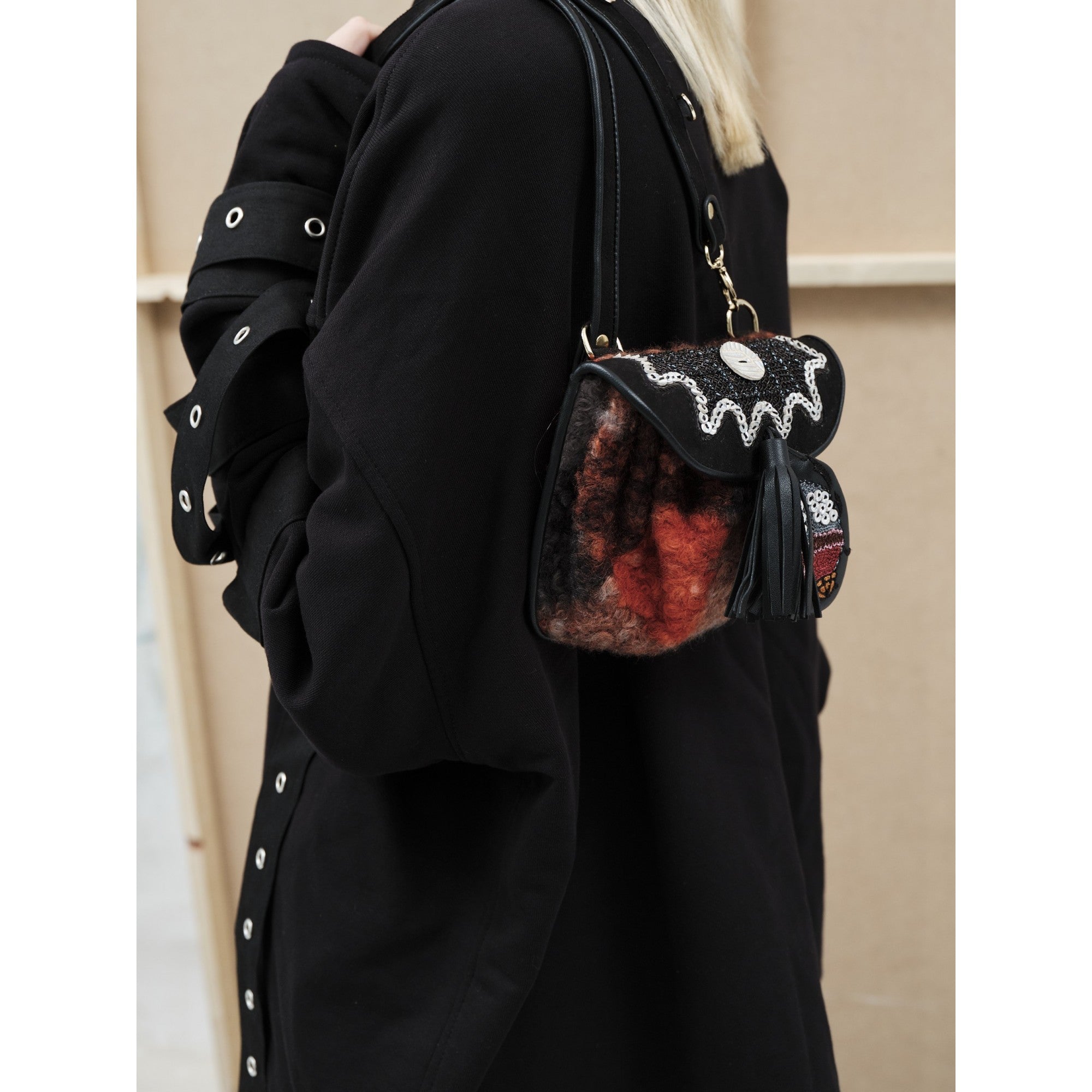 Mini Accordion Bag by Meher Kakalia worn crossbody, black and red faux shearling