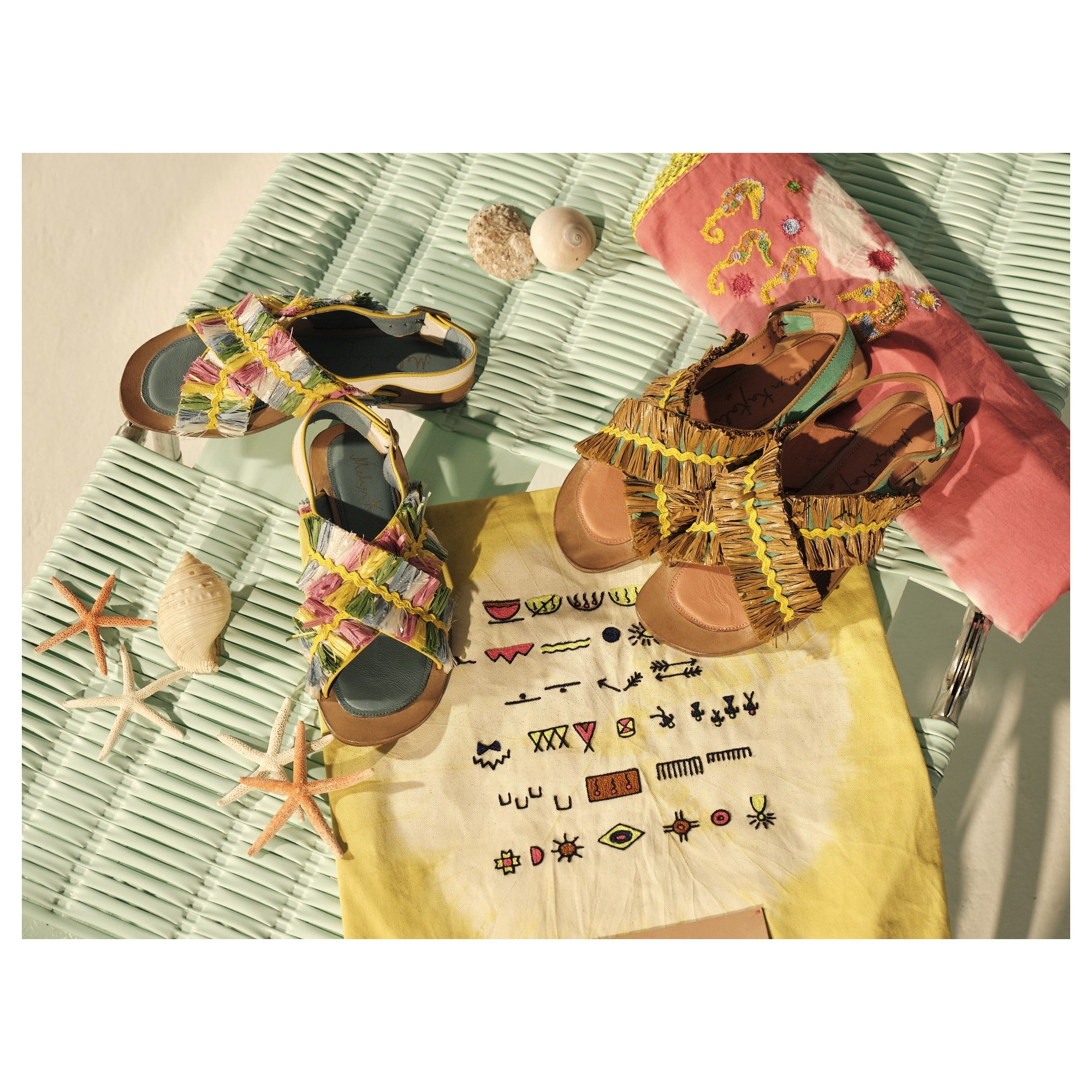 Lifestyle shot of feet wearing Meher Kakalia sandals with vibrant raffia fringe.