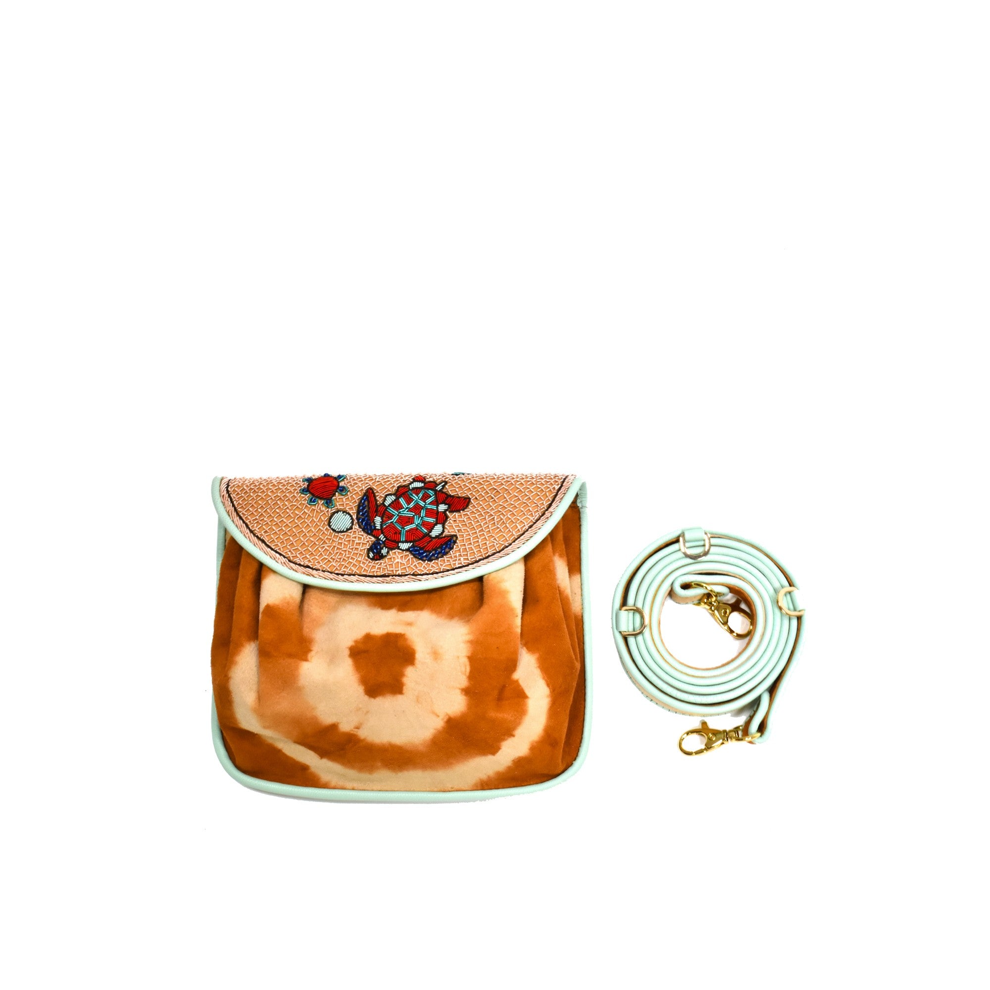 Meher Kakalia Darwin Accordion Bag in brown tie-dye, featuring hand-embroidered turtle motifs and an adjustable strap.