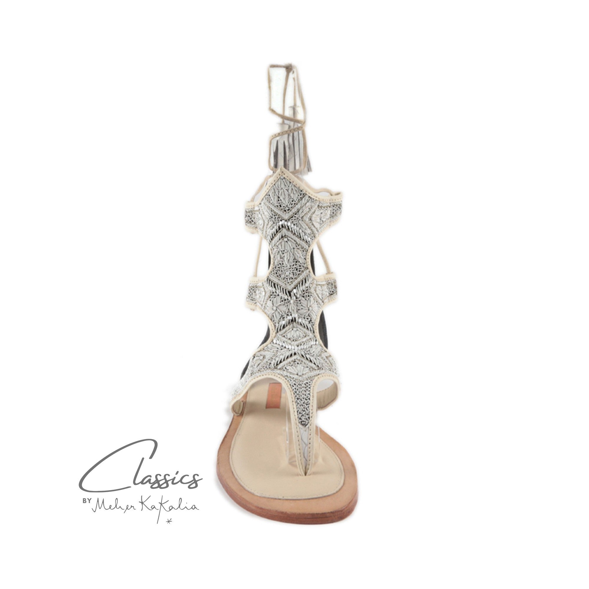 Sustainable white gladiator sandals with intricate coil embroidery, perfect for special occasions and weddings.